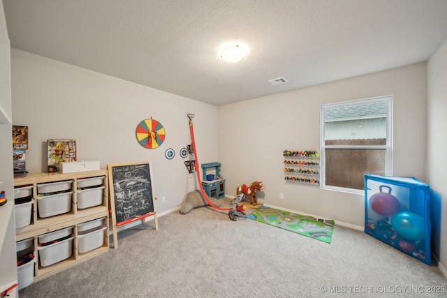 playroom with baseboards, carpet flooring, a textured ceiling, and visible vents