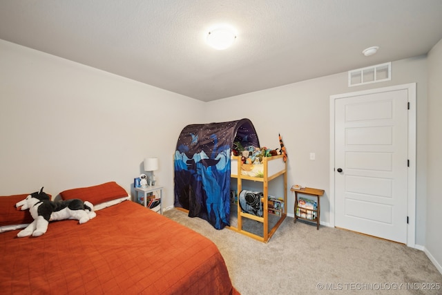 carpeted bedroom with baseboards and visible vents
