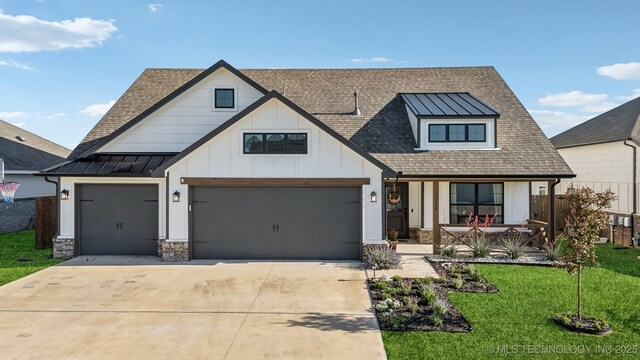 view of front facade featuring covered porch, a standing seam roof, a front lawn, concrete driveway, and a shingled roof
