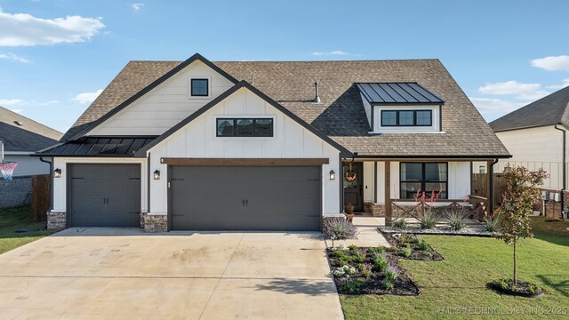 view of front of property featuring covered porch, a front yard, a standing seam roof, a shingled roof, and concrete driveway