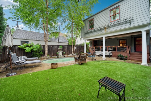 view of yard with an outdoor living space, a patio, a fenced in pool, and a fenced backyard