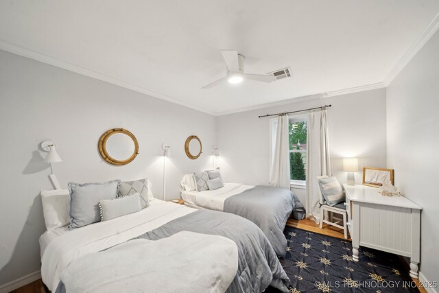 bedroom featuring crown molding, ceiling fan, dark wood-style flooring, and visible vents