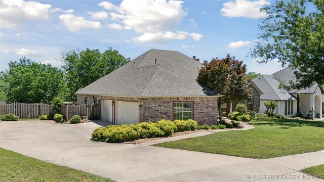 9219 N 134th E Ave, Owasso, OK 74055 - view of front of property with brick siding, a garage, concrete driveway, and a shingled roof