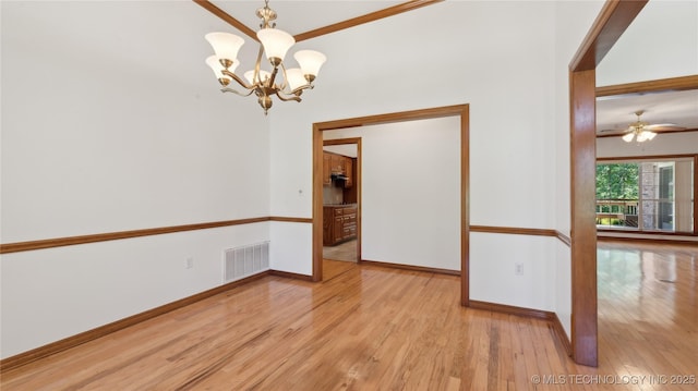 9219 N 134th E Ave, Owasso, OK 74055 - spare room featuring a chandelier, wood finished floors, baseboards, crown molding, and a ceiling fan
