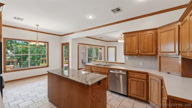 9219 N 134th E Ave, Owasso, OK 74055 - kitchen with dishwasher, a sink, a chandelier, a kitchen island, and backsplash