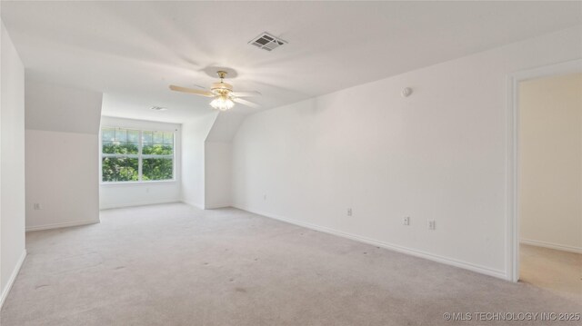 9219 N 134th E Ave, Owasso, OK 74055 - additional living space with a ceiling fan, light carpet, vaulted ceiling, and baseboards