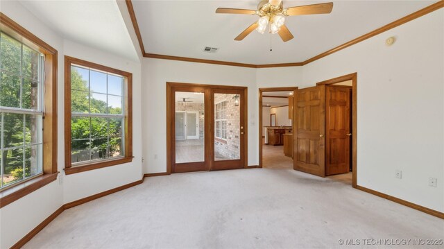 9219 N 134th E Ave, Owasso, OK 74055 - unfurnished room featuring plenty of natural light, carpet flooring, baseboards, a ceiling fan, and ornamental molding