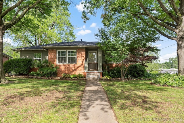view of front of property with a front yard and brick siding