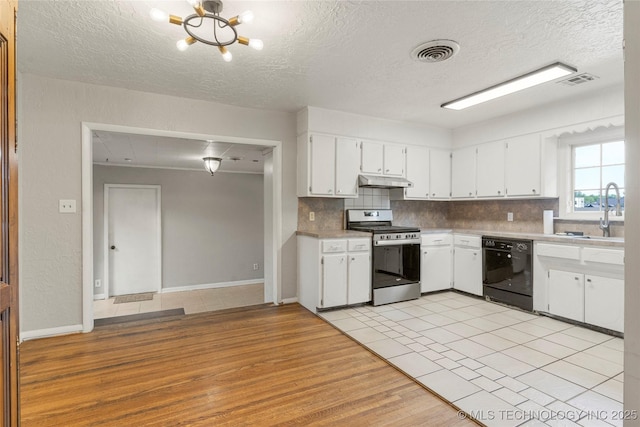 kitchen with visible vents, black dishwasher, stainless steel gas range, under cabinet range hood, and a sink