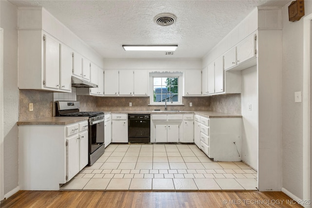 kitchen with stainless steel gas range, a sink, black dishwasher, decorative backsplash, and under cabinet range hood