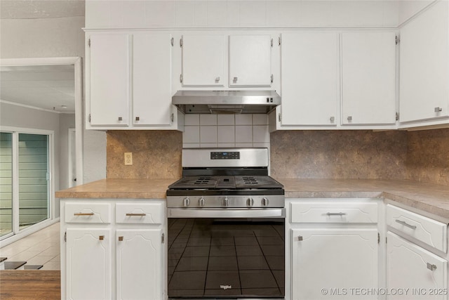 kitchen featuring stainless steel range with gas cooktop, under cabinet range hood, and white cabinets