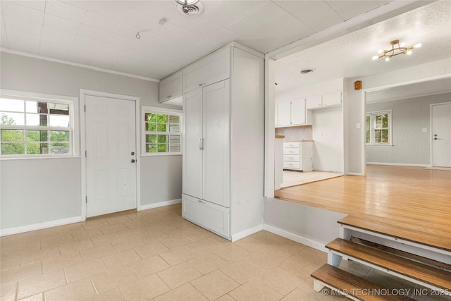 entryway featuring light tile patterned flooring and baseboards
