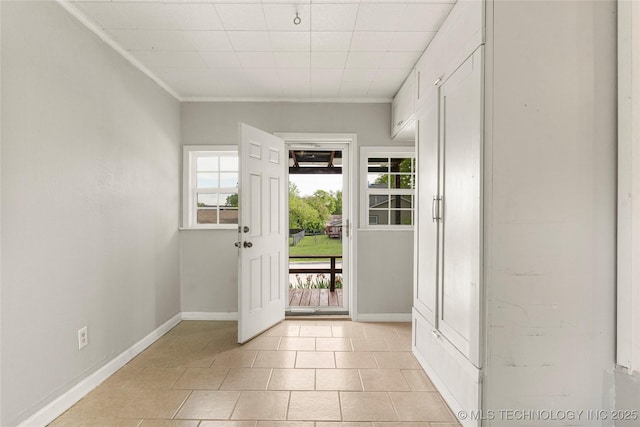 doorway to outside with light tile patterned floors and baseboards