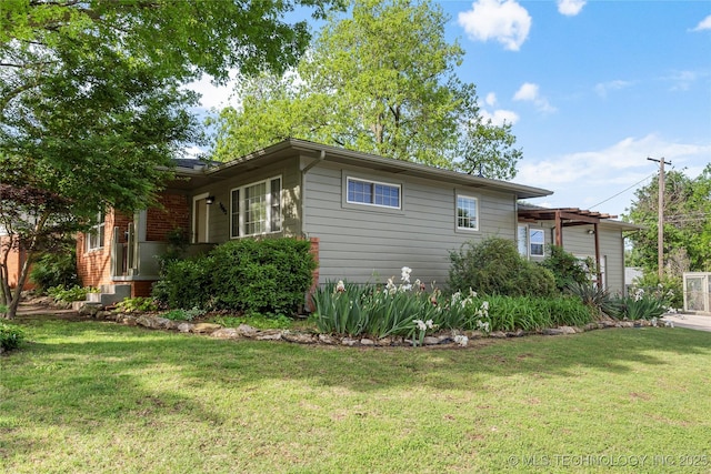 view of side of property with a lawn