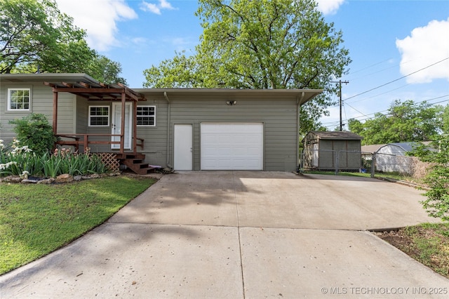 ranch-style house with fence, an attached garage, and driveway