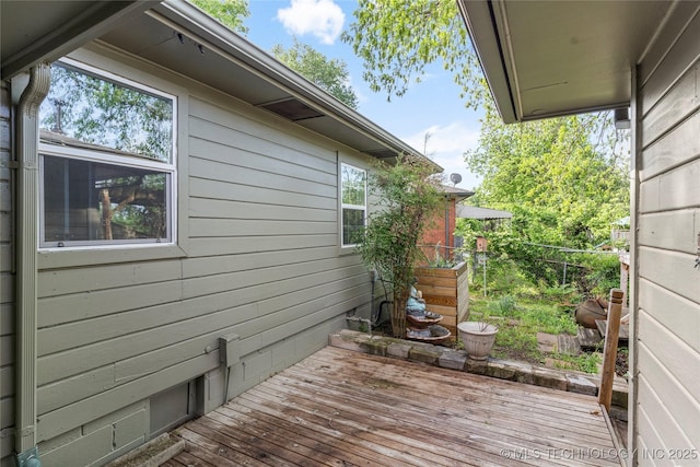 view of home's exterior with fence and a wooden deck