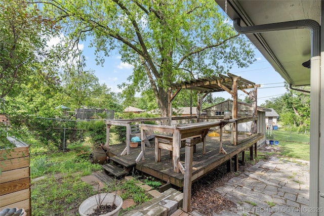 deck with a pergola and a fenced backyard