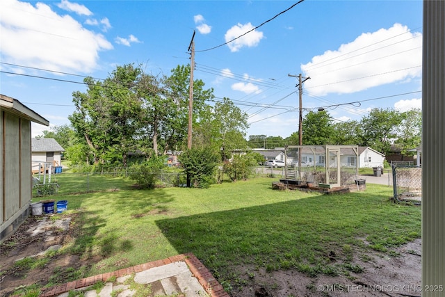 view of yard featuring a garden and a fenced backyard