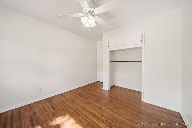 unfurnished bedroom with a ceiling fan, baseboards, wood finished floors, and a closet