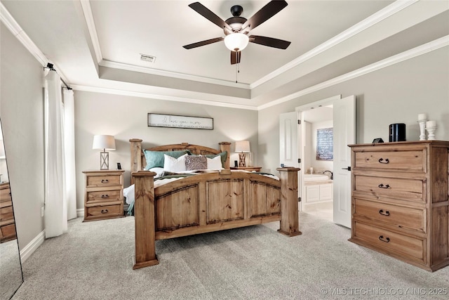 bedroom featuring crown molding, light carpet, a tray ceiling, and visible vents