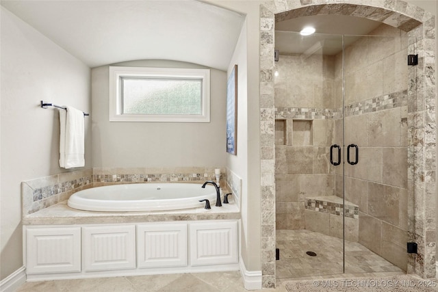 full bathroom featuring a shower stall and a garden tub