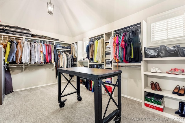 walk in closet featuring carpet floors and lofted ceiling