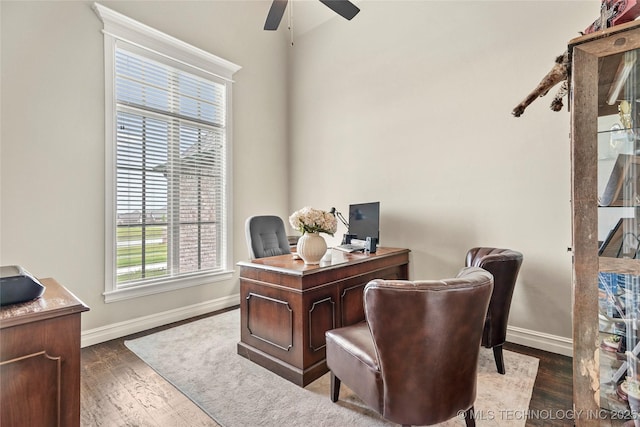 office featuring baseboards, ceiling fan, and wood finished floors