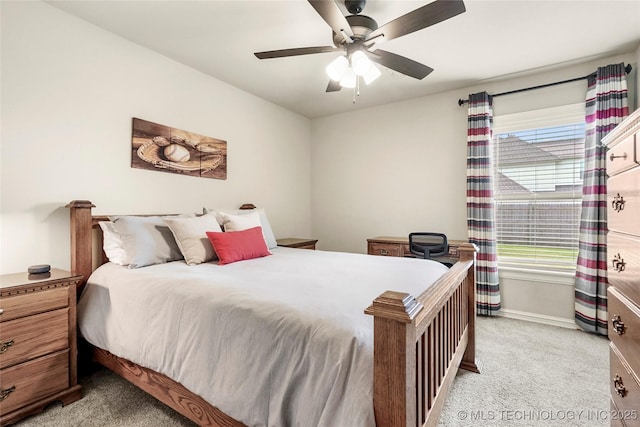 bedroom featuring baseboards, ceiling fan, and light colored carpet