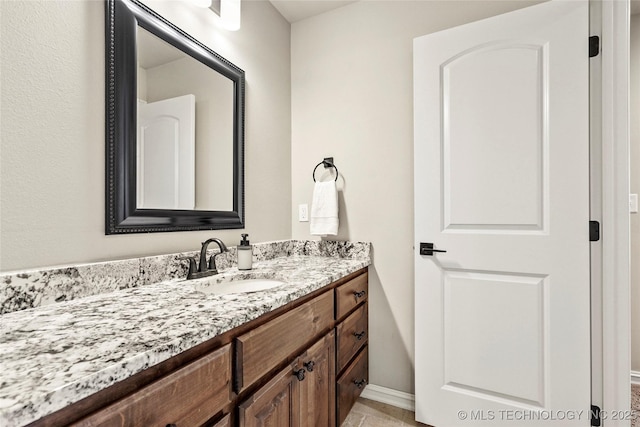 bathroom featuring vanity and baseboards