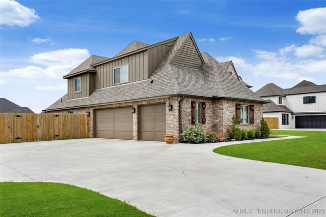 16622 S 2 W Ave, Glenpool, OK 74033 - view of front of property featuring driveway, brick siding, fence, an attached garage, and a shingled roof