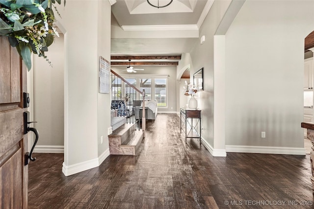 foyer entrance featuring crown molding, stairs, baseboards, a ceiling fan, and dark wood finished floors
