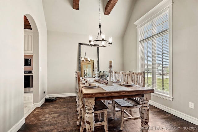 dining space featuring arched walkways, high vaulted ceiling, a chandelier, baseboards, and wood finished floors