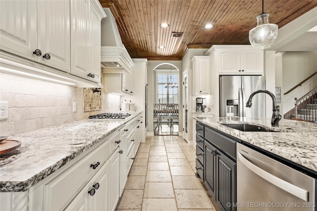 kitchen featuring custom range hood, white cabinets, wooden ceiling, and stainless steel appliances