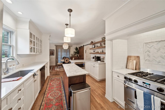 2252 S Troost Ave, Tulsa, OK 74114 - kitchen with crown molding, light wood-style floors, tasteful backsplash, a sink, and appliances with stainless steel finishes