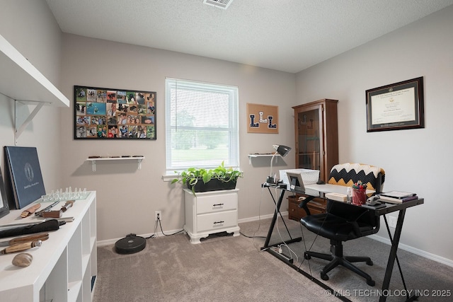 home office with baseboards, carpet flooring, a textured ceiling, and visible vents