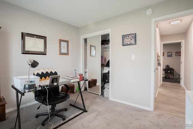 office area with baseboards and light carpet