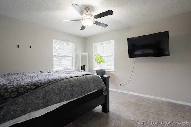 bedroom featuring a textured ceiling, baseboards, a ceiling fan, and carpet