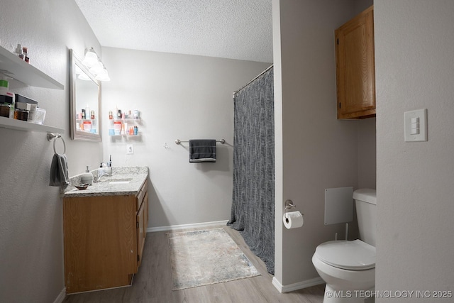 full bath featuring vanity, wood finished floors, toilet, a textured ceiling, and a shower with curtain