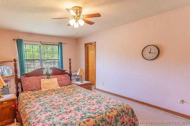 bedroom with carpet floors, a textured ceiling, baseboards, and ceiling fan