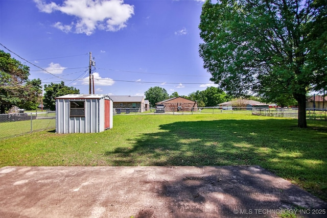view of yard featuring an outdoor structure, a shed, a fenced backyard, and a patio area