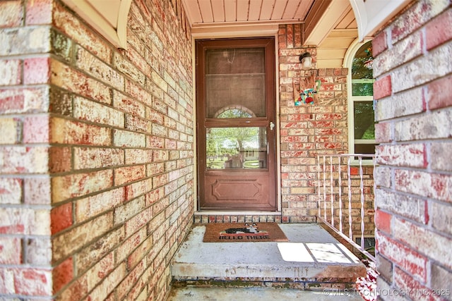 property entrance with brick siding