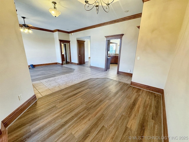 spare room with ceiling fan, ornamental molding, tile patterned floors, and baseboards