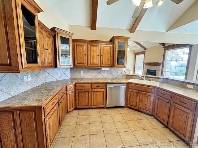 kitchen featuring dishwasher, a sink, a ceiling fan, and brown cabinetry