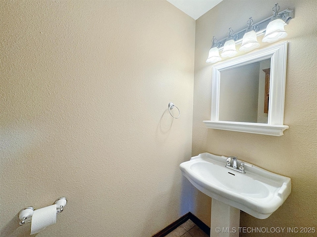 bathroom featuring a sink and tile patterned flooring