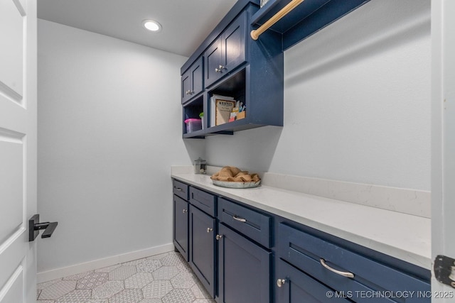 interior space with baseboards and recessed lighting