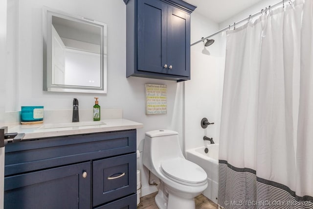 bathroom featuring vanity, shower / bath combo with shower curtain, toilet, and wood finished floors