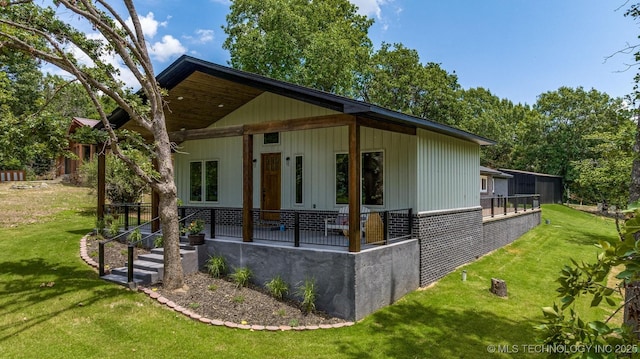 view of side of property with a lawn and brick siding