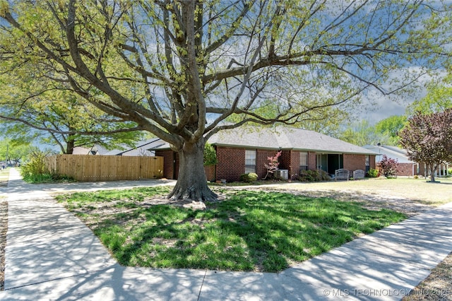 single story home with brick siding and fence