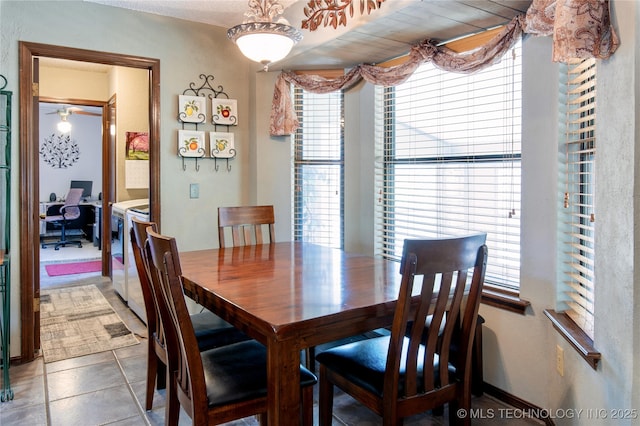 tiled dining room featuring plenty of natural light