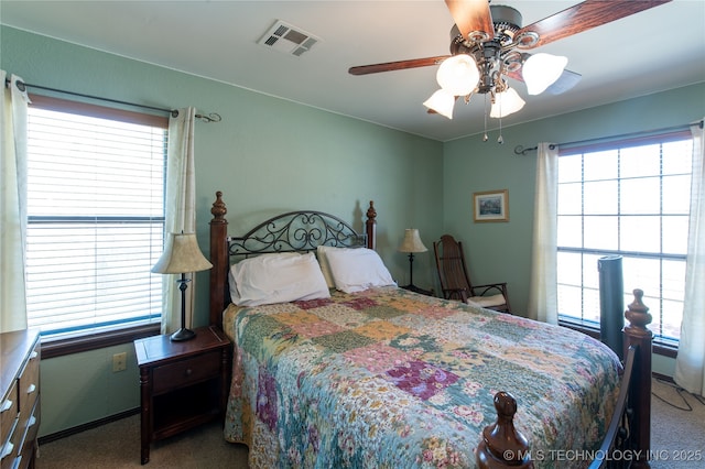 bedroom featuring a ceiling fan, baseboards, visible vents, and carpet